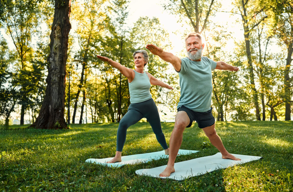 couple doing yoga and discussing Longer. Healthier. Better Symposium