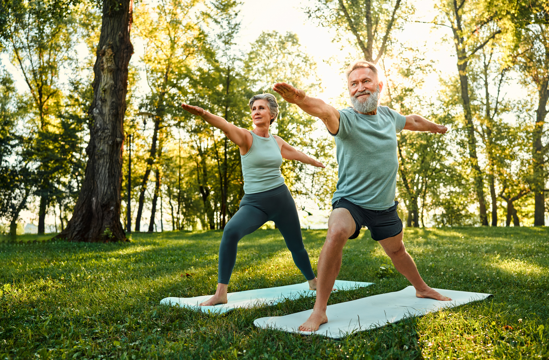 couple doing yoga and discussing Longer. Healthier. Better Symposium